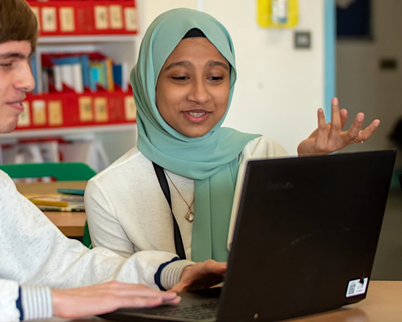 2 Sixth Form students working on a laptop