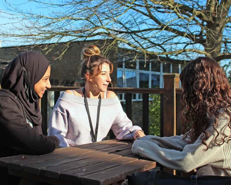 girls outside on bench Sixth Form students sitting on bench